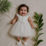 Baby girl in premium satin and net baptism dress set with cap sleeves and pearl accents