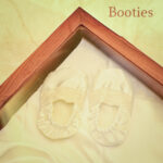 Satin baby baptism booties with lace detailing in wooden display box