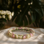 Amara floral baptism tiara with white and pink roses on satin cloth