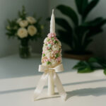 Handcrafted baptism candle decorated with roses, pearls, and satin ribbon