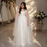 Cressida white communion gown for girls with embroidered bodice and long flowing cape sleeves