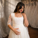 Close-up of Rosaline Holy Communion gown bodice and designer lace sleeve detail