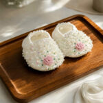 White pearl beaded baby booties with pink floral detail for baptism and christening