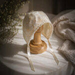 White floral lace baptism bonnet with scalloped edge and satin ribbon ties