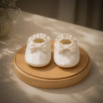 White satin baby booties with bow detail for baptism and christening outfit